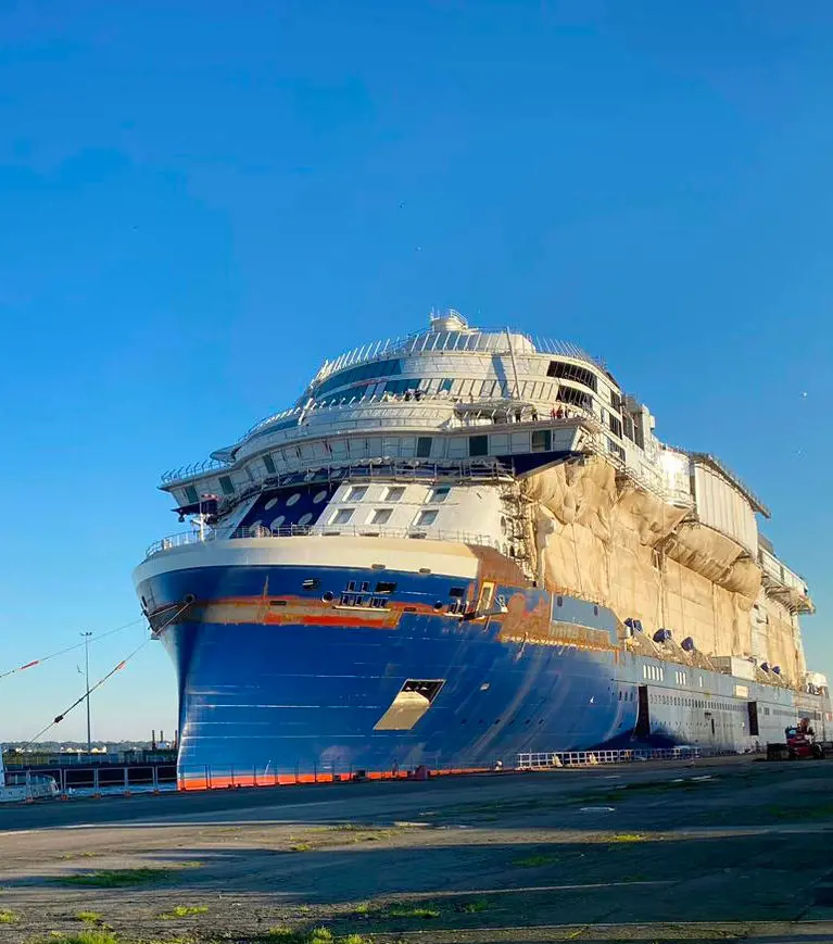The front view of the under construction Celebrity Ascent docked at a port in January 2023