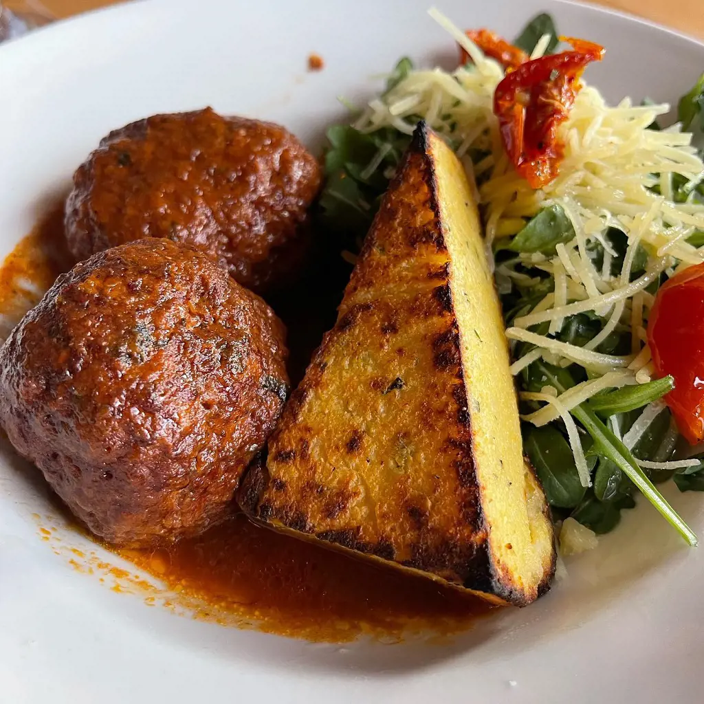 Homemade Meatball Special with Creamy Polenta Cake at Harvest on Fort Pond