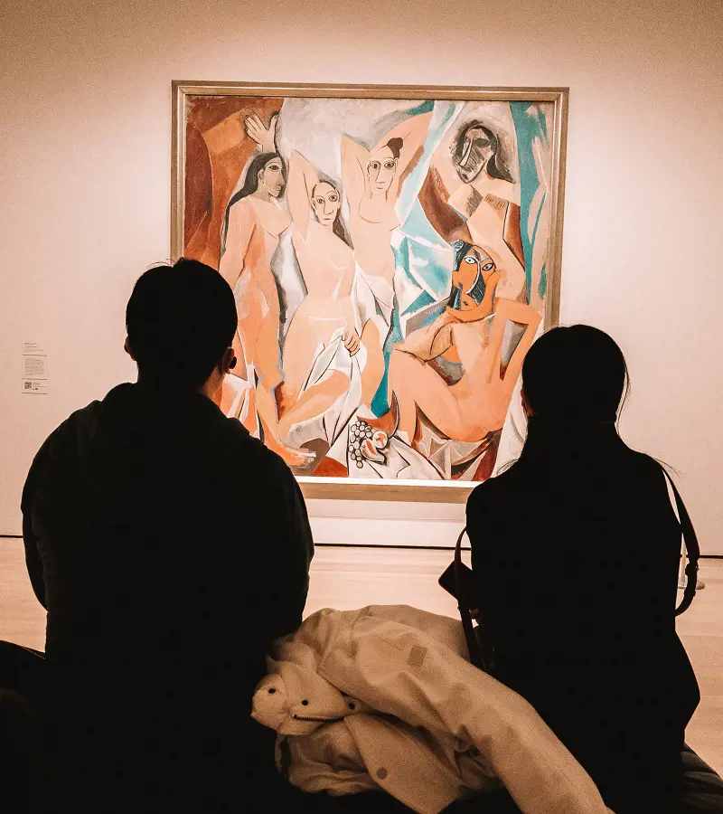Two people looking at art in The Museum of Modern Art. (Photo By: Johnell Pannell)