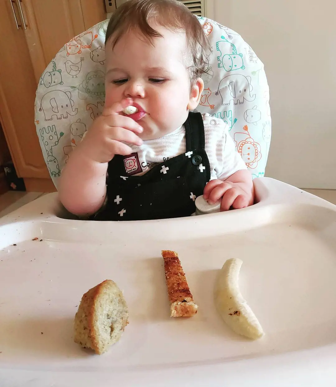 Baby munches on tasty snacks after getting introduced to solid foods